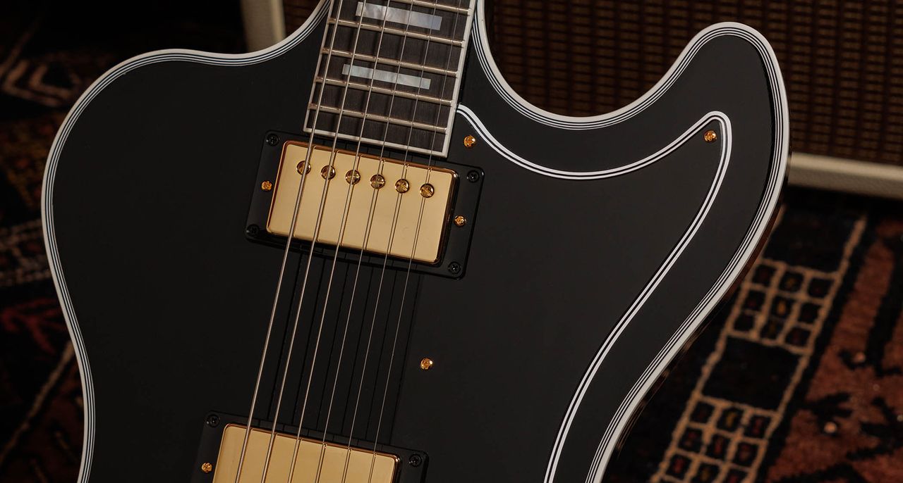 Gibson RD Custom: the cult-classic electric guitar returns in an Ebony finish, with the full Custom aesthetic of block inlays on an ebony fingerboard, multi-ply binding, and gold hardware and pickup coverings.