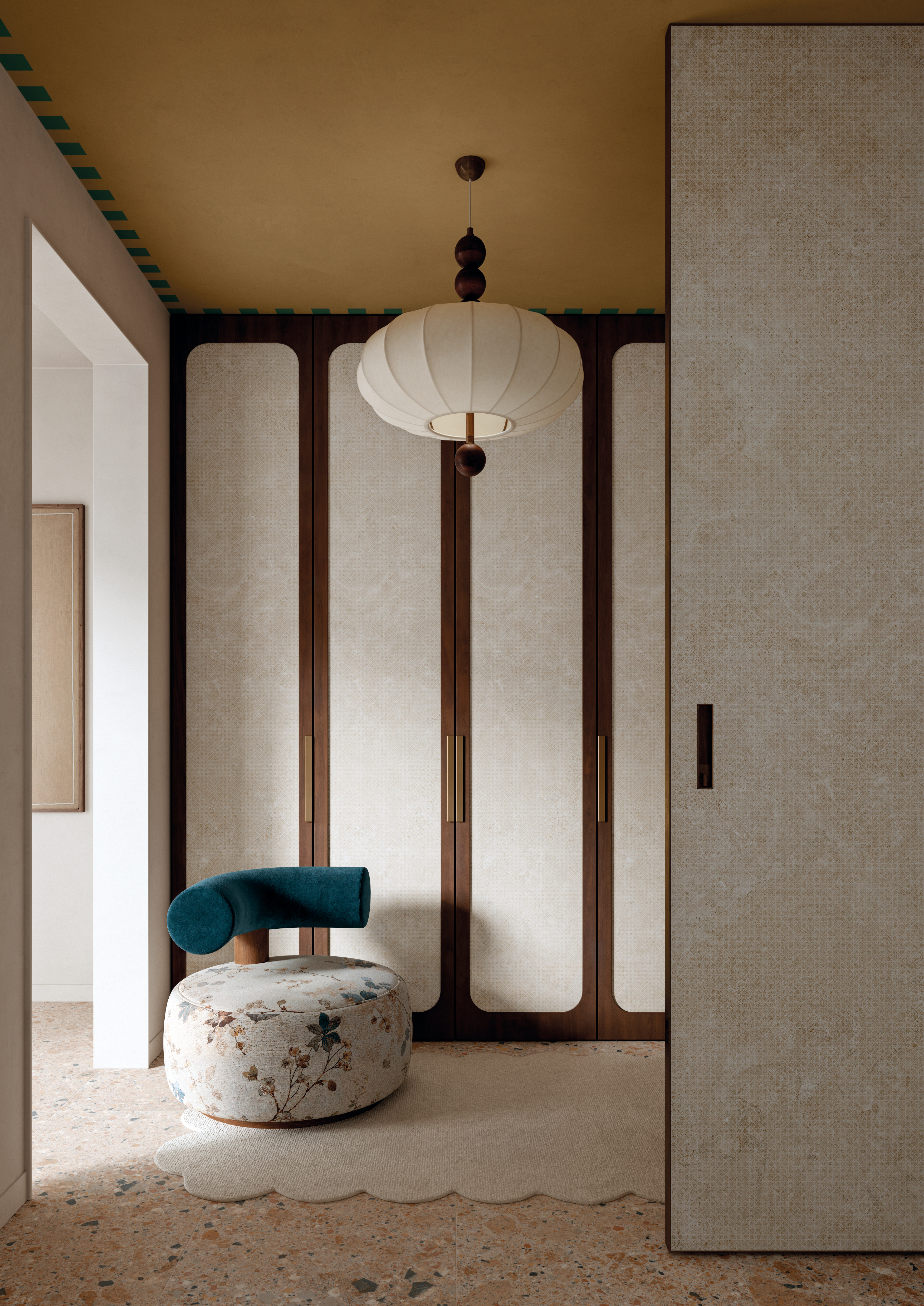 A neutrally tinted interior with a floral-inspired pendant lamp in paper, an abstract pale blue artwork, a round glossy vase filled with flowers, textile-clad brown walls, and a white ceramic sconce.