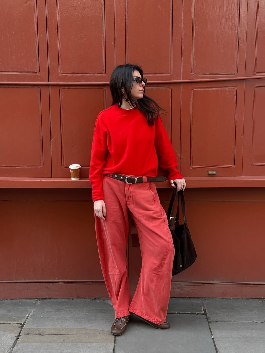 Influencer @francescasaffari wears tomato red linen trousers with a lace trim tank top and black flipflops.