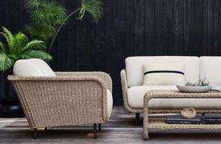 A wicker lounge set with tropical planting
