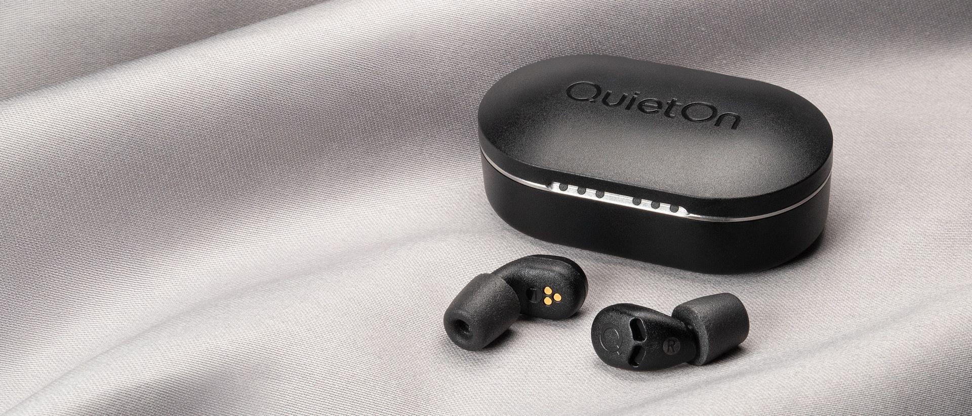 QuietOn 4 Sleep Earbuds on a gray background.