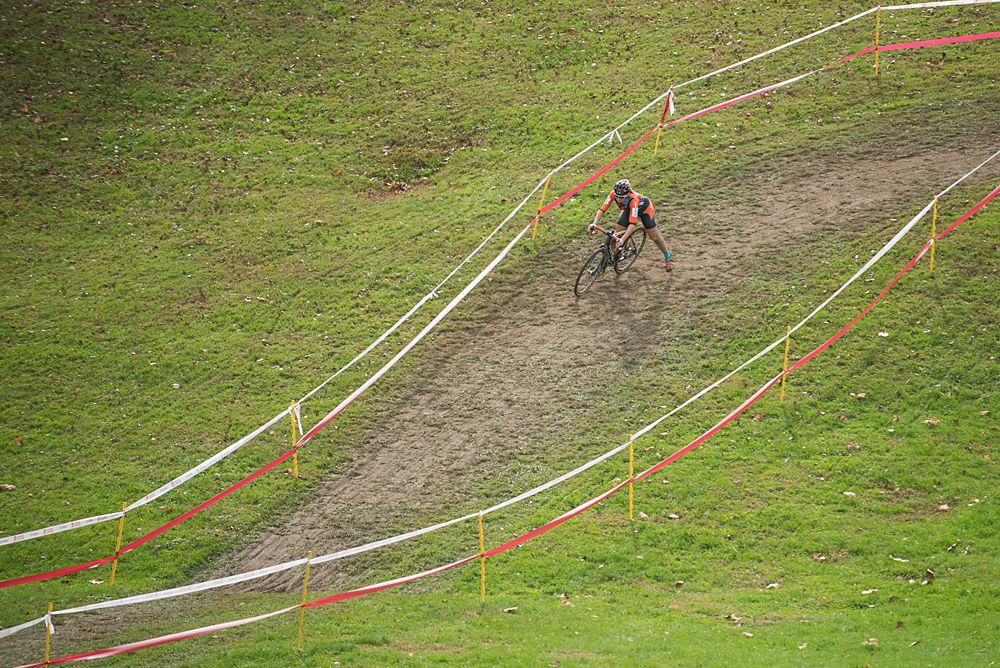 A rider makes her way down the course while trying to stay upright on a fast mudy descent.