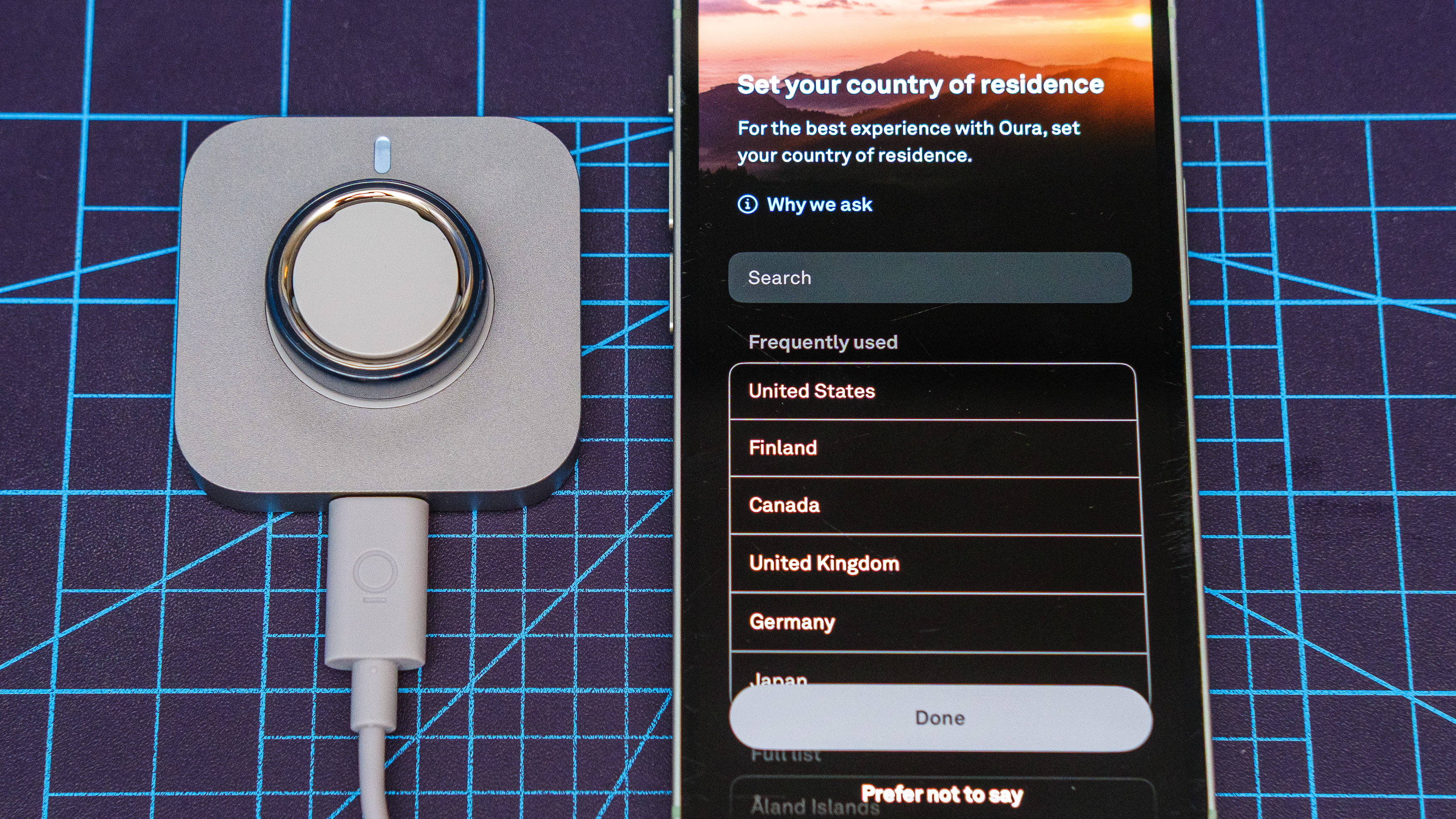 Oura Ring 4 Ceramic close-up showing the setup and pairing process using an iPhone