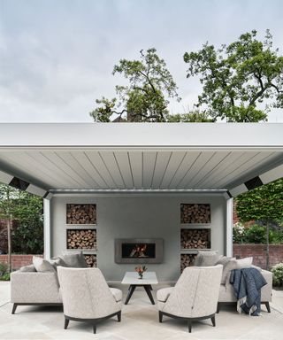 outdoor fireplace on patio with chairs and table