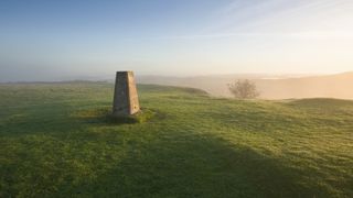 Trig point on misty hilltop