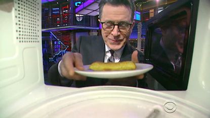 Stephen Colbert uses the microwave camera prop