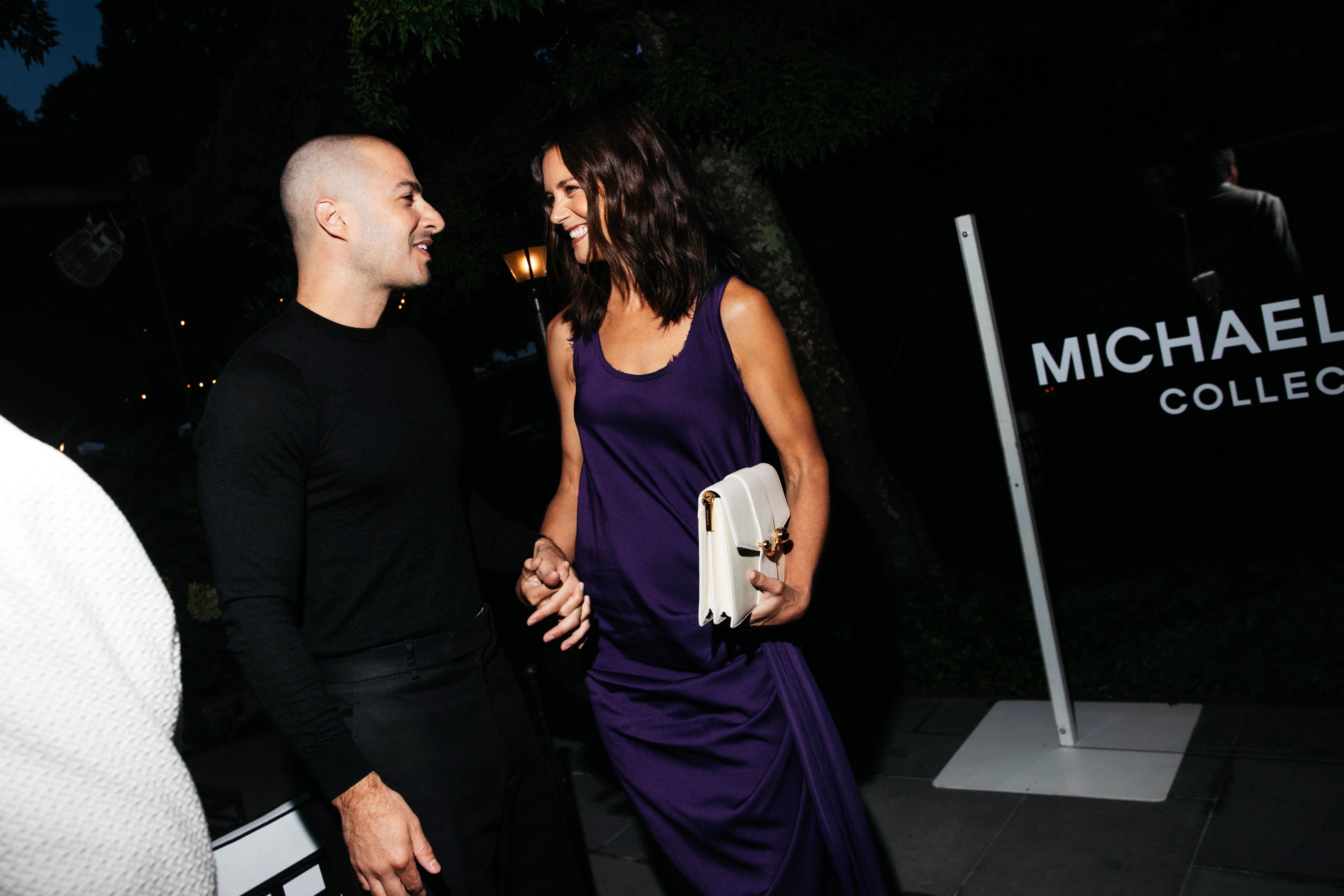 Katie Holmes wearing a purple dress and red shoes at the Michael Kors 45th Anniversary Collection Dinner held at Swifty's at The Hedges Inn on August 20, 2026 in East Hampton, New York