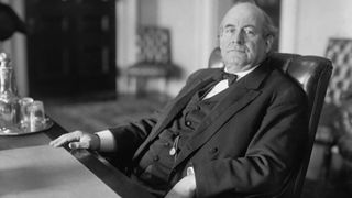 Black and white photo of presidential candidate William Jennings Bryan seated at desk