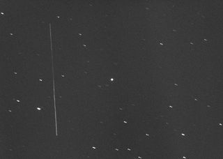 The huge asteroid 3122 Florence appears as a bright dot (center) in this photo taken with a large amateur telescope on Aug. 28, 2017, by Gianluca Masi of the Virtual Telescope Project. At the time, Florence was about 5 million miles (8 million kilometers) from Earth. The long vertical streak at left is the geostationary satellite AMC-14.