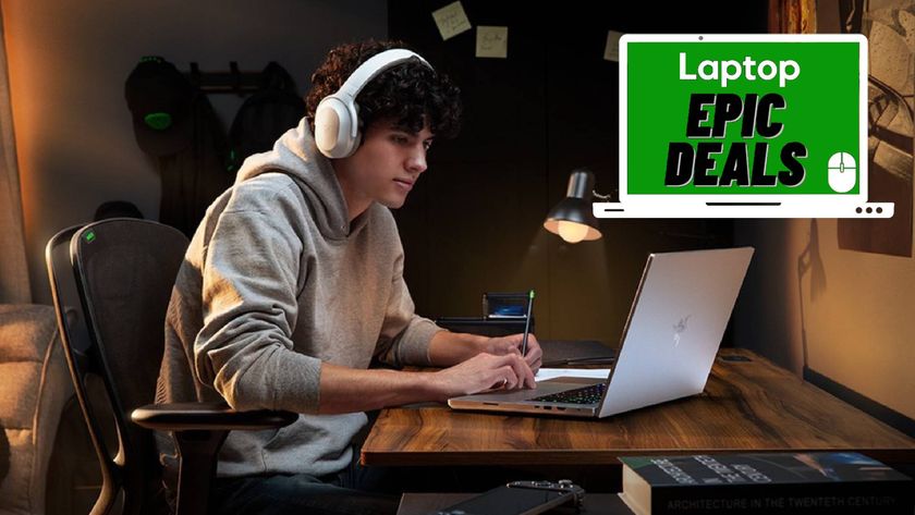 Student sitting at desk using Razer Blade laptop while wearing a Razer Opus X headphones