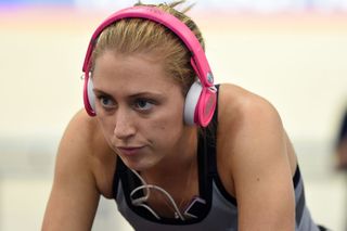 Laura Kenny uses on ear headphones when warming up. She is shown in this image with pink headphones on