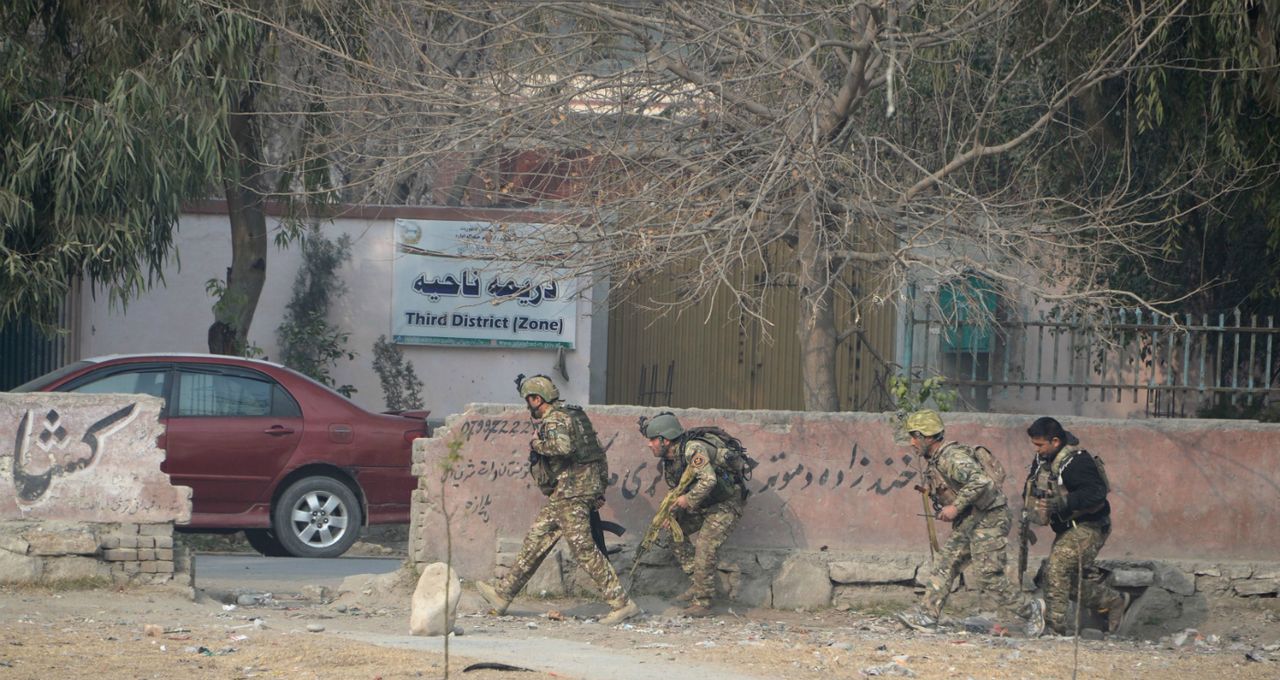 Afghan army soldiers take positions near the office of Save the Children 