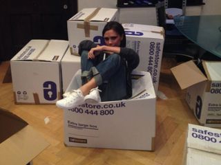 Victoria Beckham gets stuck in while packing clothes for charity