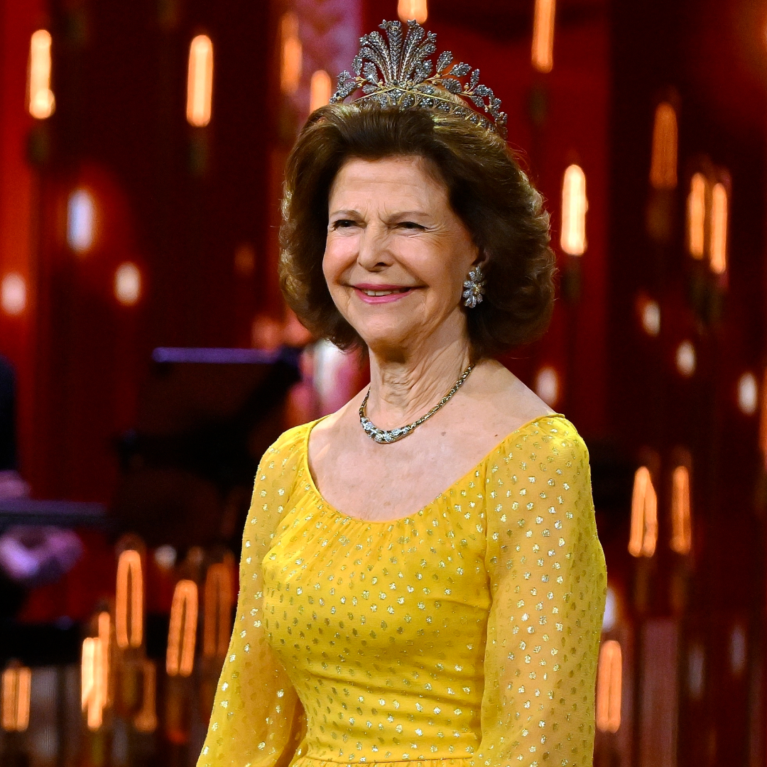 Queen Silvia wearing a yellow gown and tiara