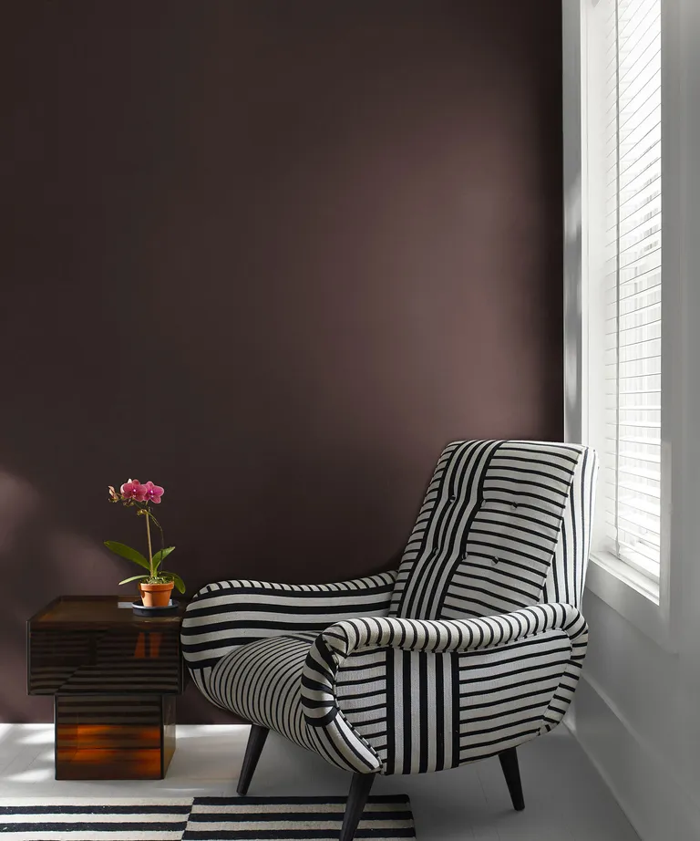 black and white armchair against a dark wall