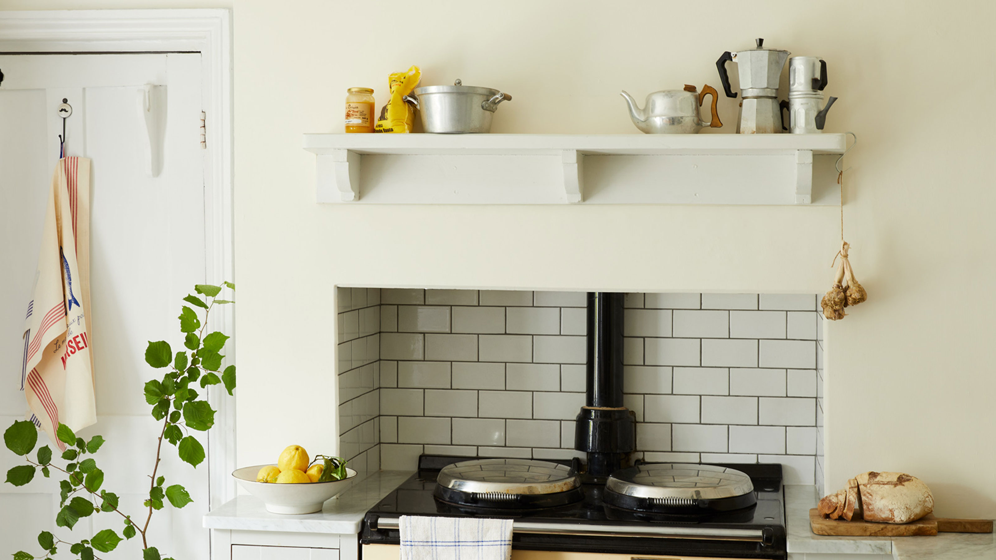 off-white kitchen with cream AGA and metro tiled splashback