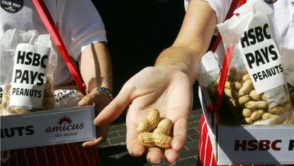 Striking HSBC employees offer peanuts to arriving HSBC shareholders outside the entrance to the Bank's AGM in London, 27 May
