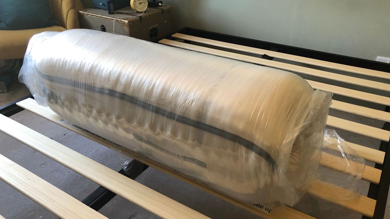 The Nolah Natural Mattress unboxed, rolled, and wrapped in plasticd