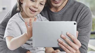 Samsung Galaxy Tab A 8.0" (2019) held up in one hands and being used by a child and an adult