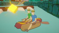 Paddle Paddle Paddle screen - two guys sitting side by side on a giant hot dog, holding paddles, staring at a floating gold nugget
