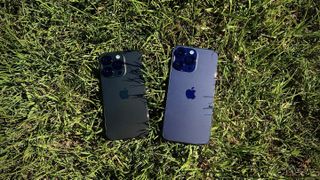 Two iPhone 14 Pros next to each other on grass.