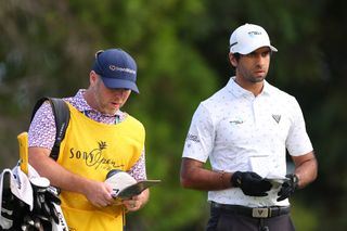 Aaron Rai speaks to his caddie during the first round of the Sony Open