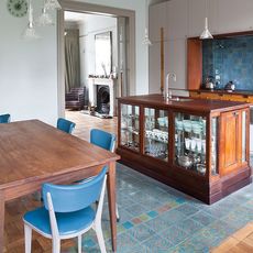 kitchen with dining table and chairs and crockery units