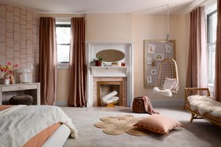 A bedroom with pastel walls, an abstract wallaper, wall-to-wall carpeting and a swing