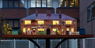 Grayson Perry first public artwork in London, a sculpture of miniature houses, lit up from within