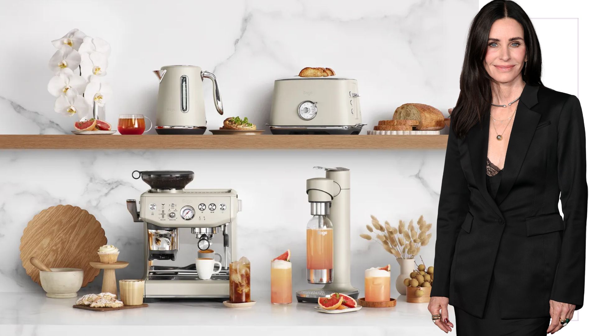 A cutout of Courteney Cox next to the Sage Barista Express Impress on a coffee station with a marble background