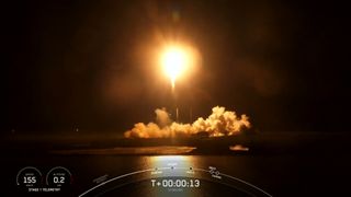 A SpaceX Falcon 9 rocket carrying 56 Starlink satellites launches at night from Florida on May 14, 2023.