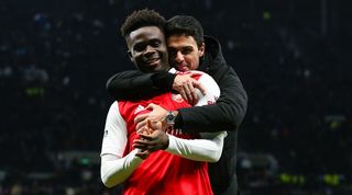 Arsenal manager Mikel Arteta hugs Bukayo Saka after the Gunners' derby win over Tottenham in January 2023.