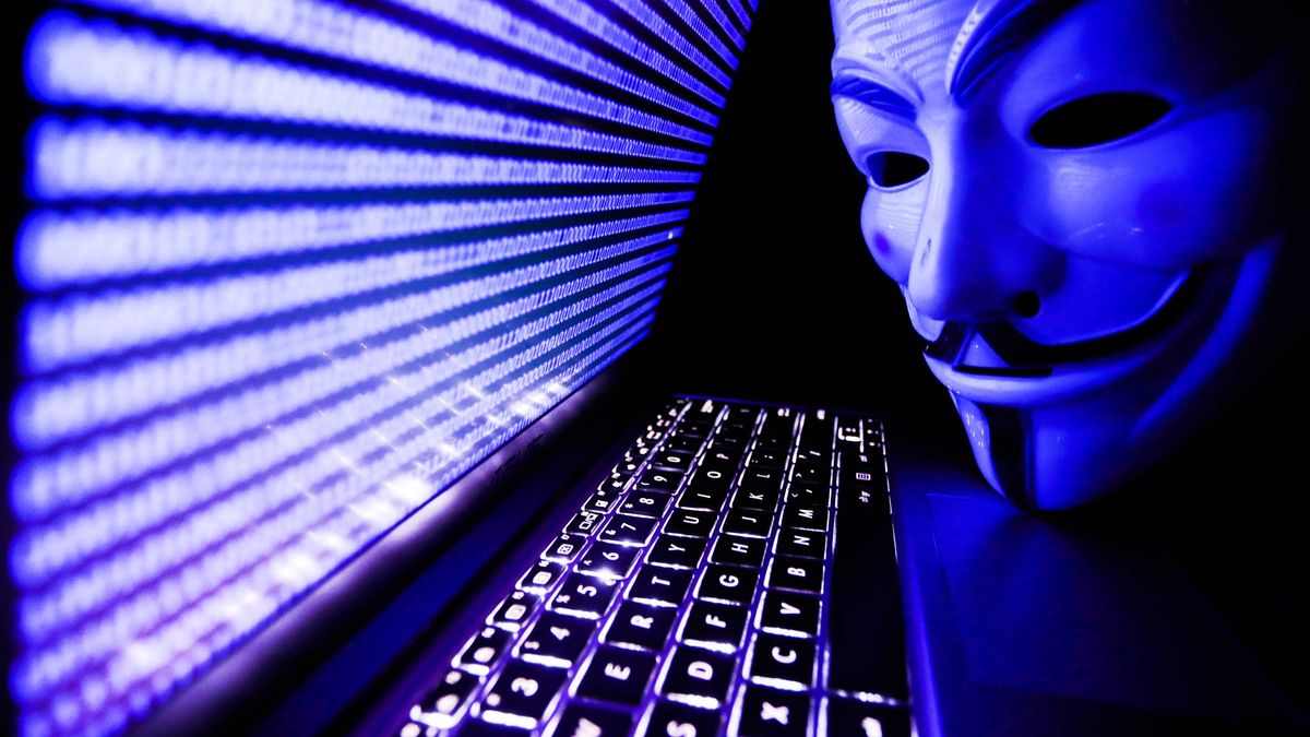 Binary code displayed on a laptop screen and Guy Fawkes mask are seen in this illustration photo.