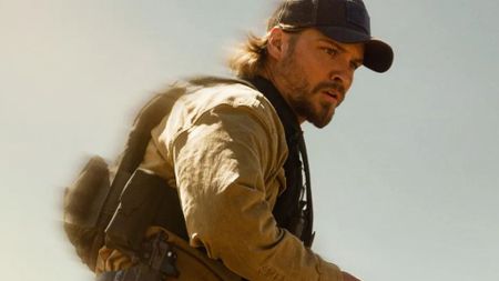 Luke Grimes looks at something off-screen