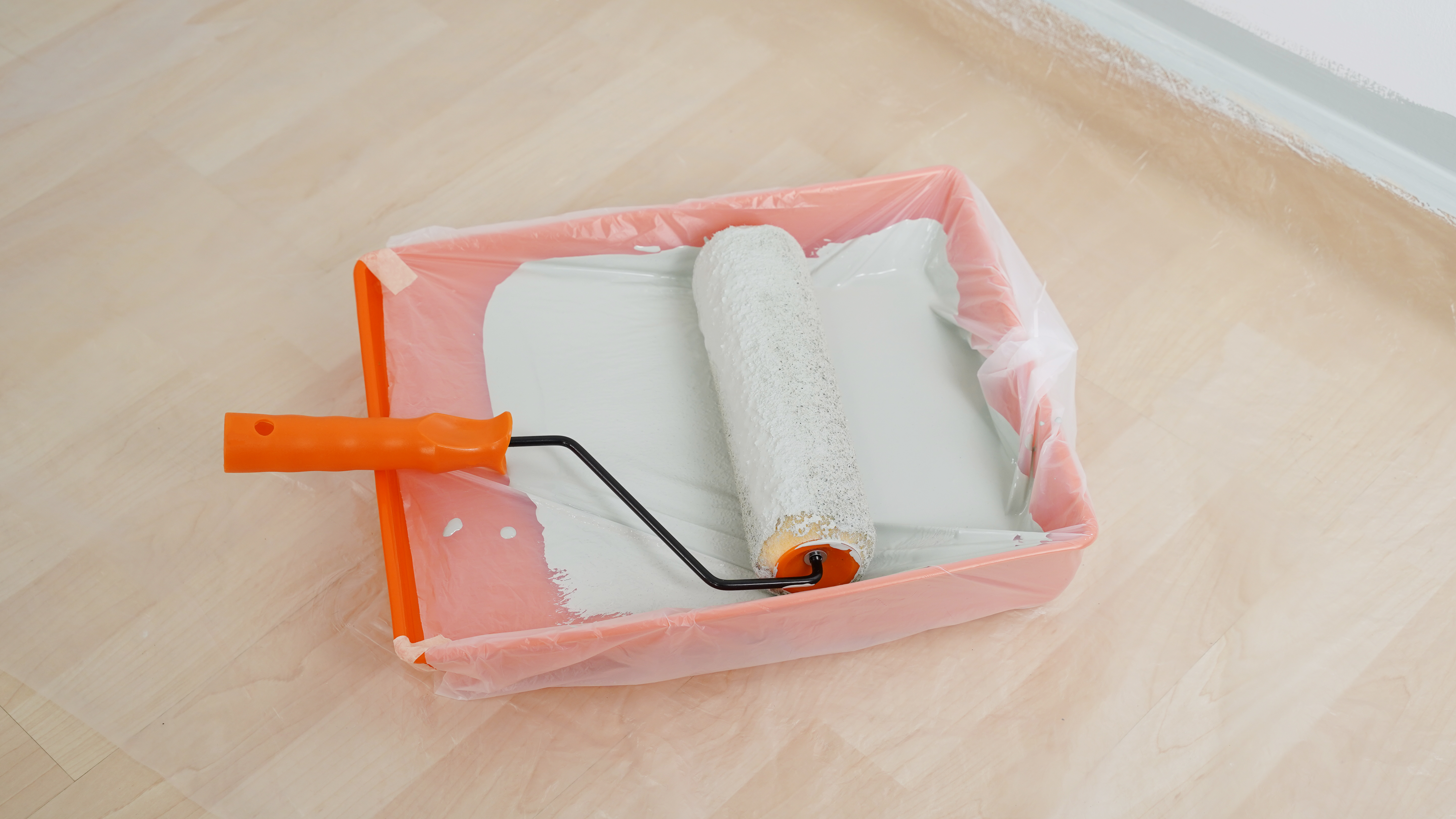 Plastic bag on orange paint tray