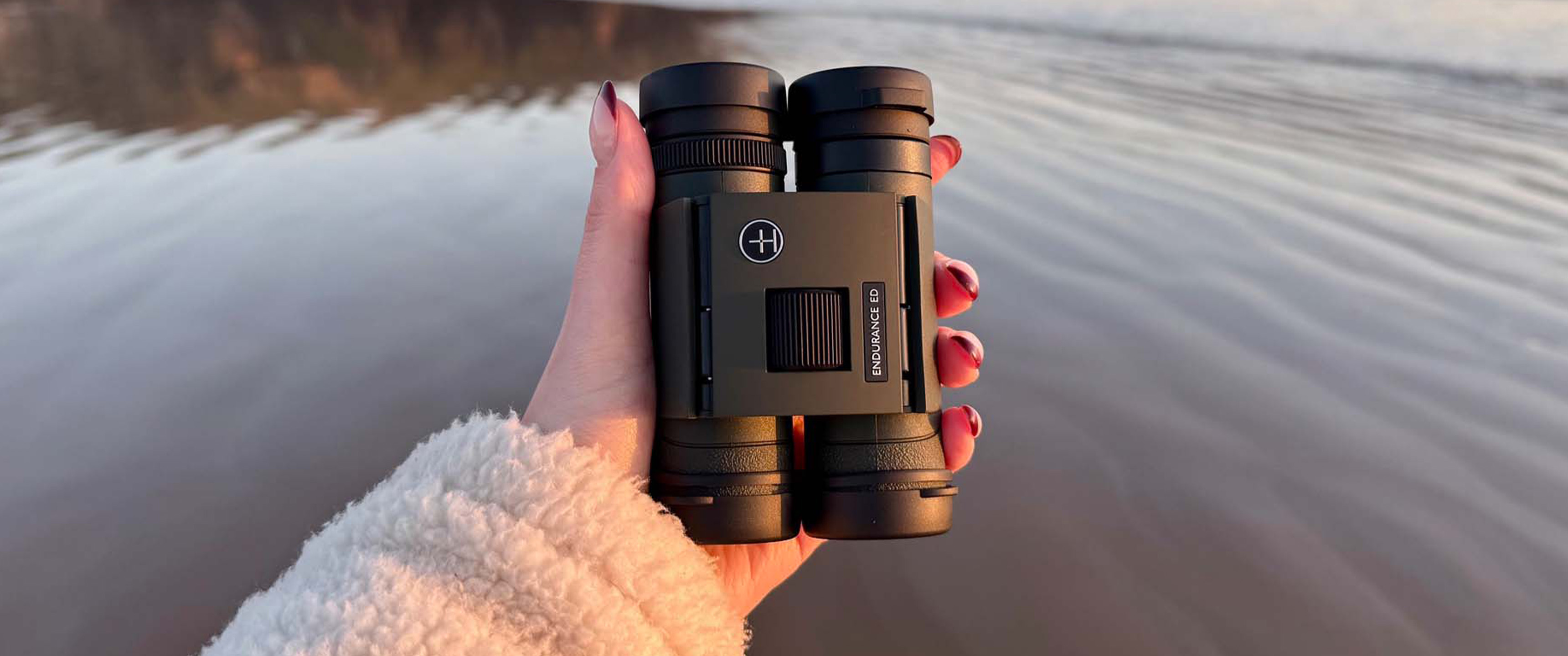 Hawke Endurance ED 8x25 in the hand at a coastal location