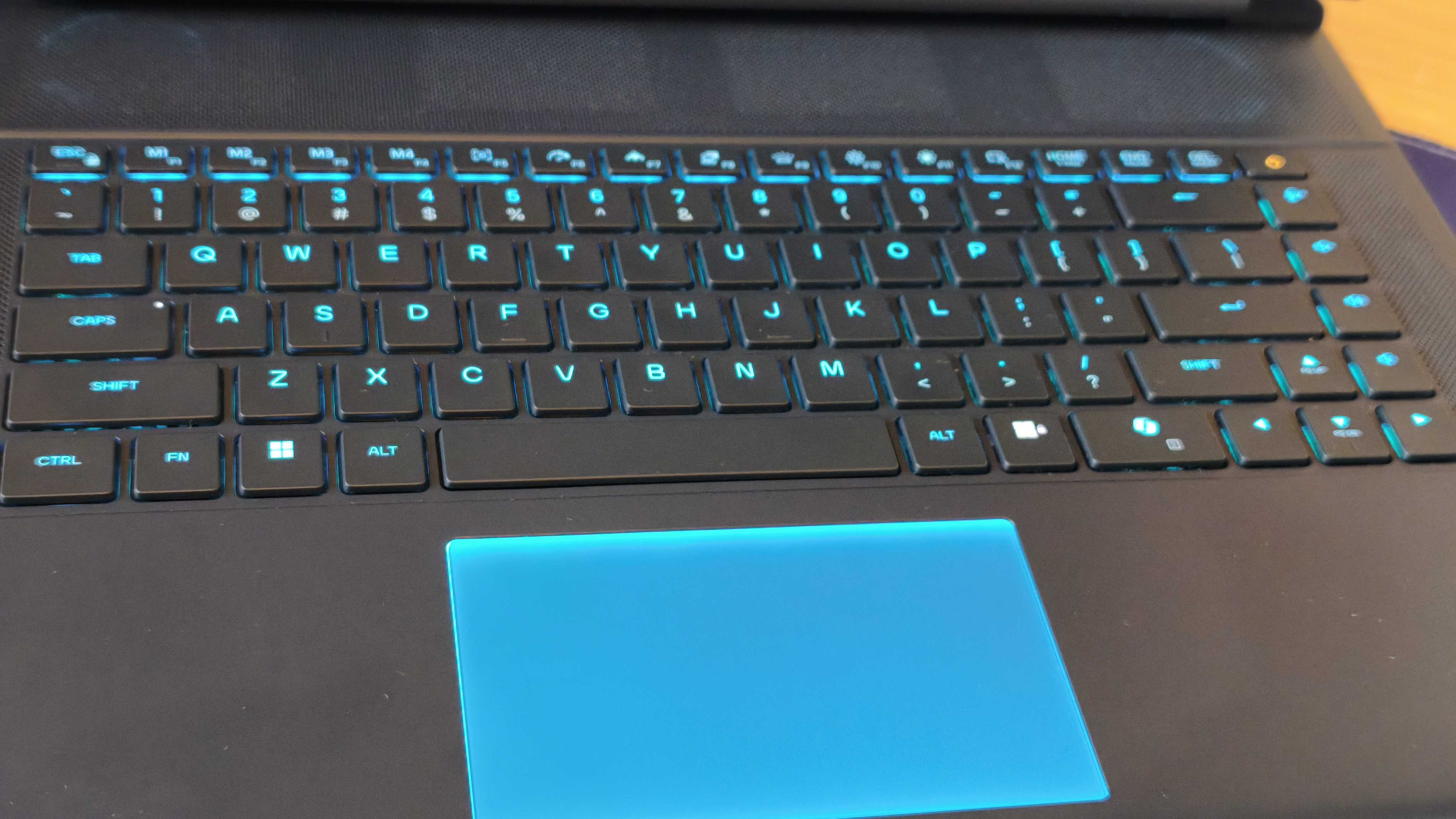 An Alienware 16 Area-51 laptop on a wooden desk