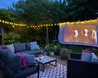 outdoor corner sofa, festoon lights and a outdoor projector and screen