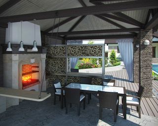 modern outdoor covered dining area with fireplace