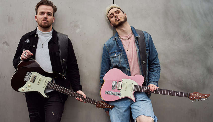 Quentin Godet (left) and Pierre Danel of the band Kadinja stand with their new six-string Vola signature guitars