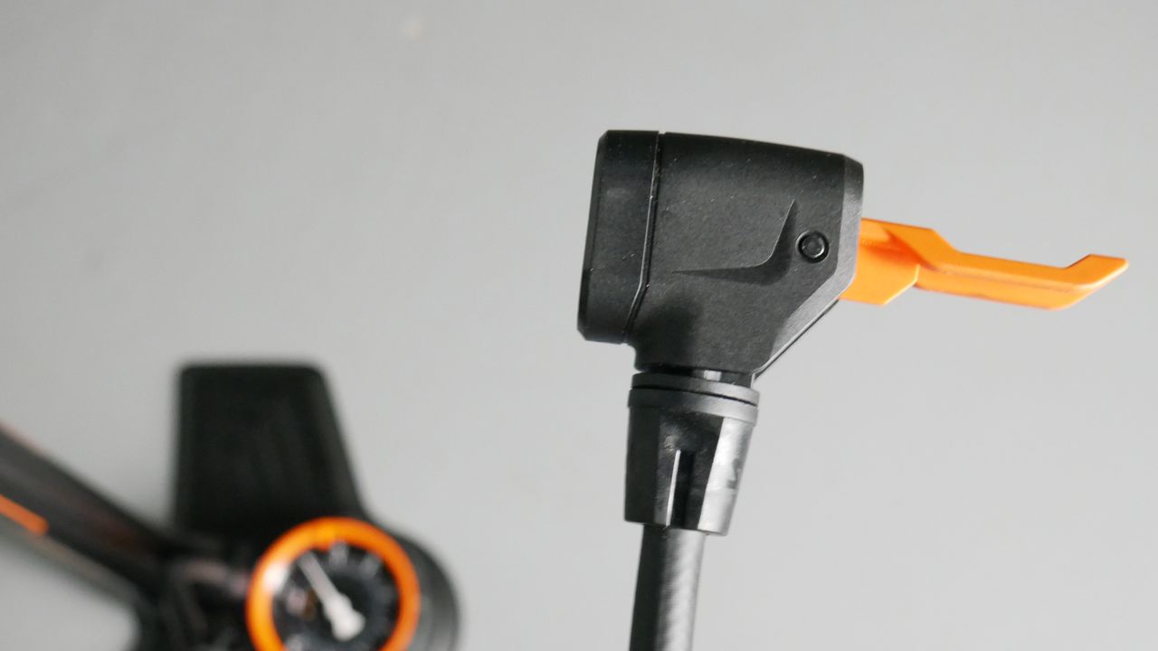 Detailed shot of the SKS Air-X-plorer bike track pumps head, which features a black body and orange lever