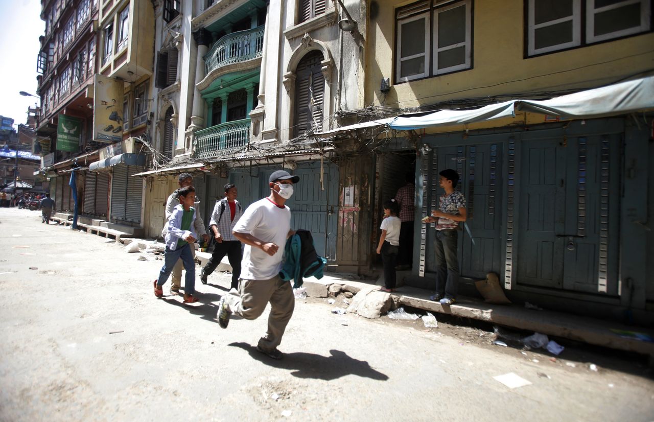 A man runs to safety in Nepal.