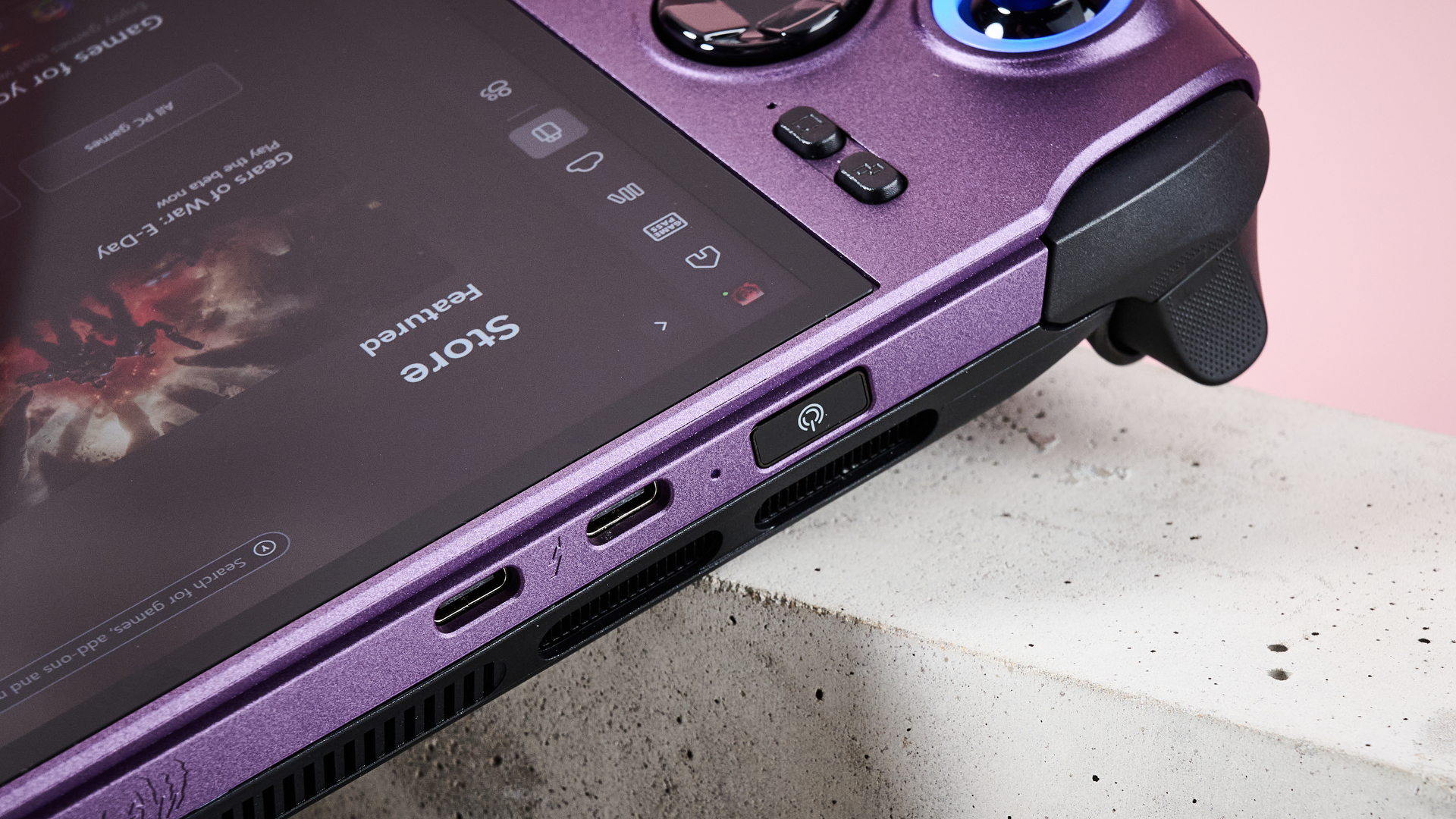 A closeup of the top left corner of MSI Claw 8 EX AI+, showing its left trigger, left shoulder button, fingerprint scanner, and two Thunderbolt 4 ports.