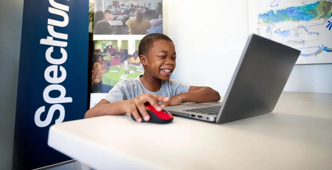 Young kid using a laptop 