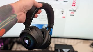 Razer Kraken V4 Pro gaming headset on a desk and with RGB enabled.