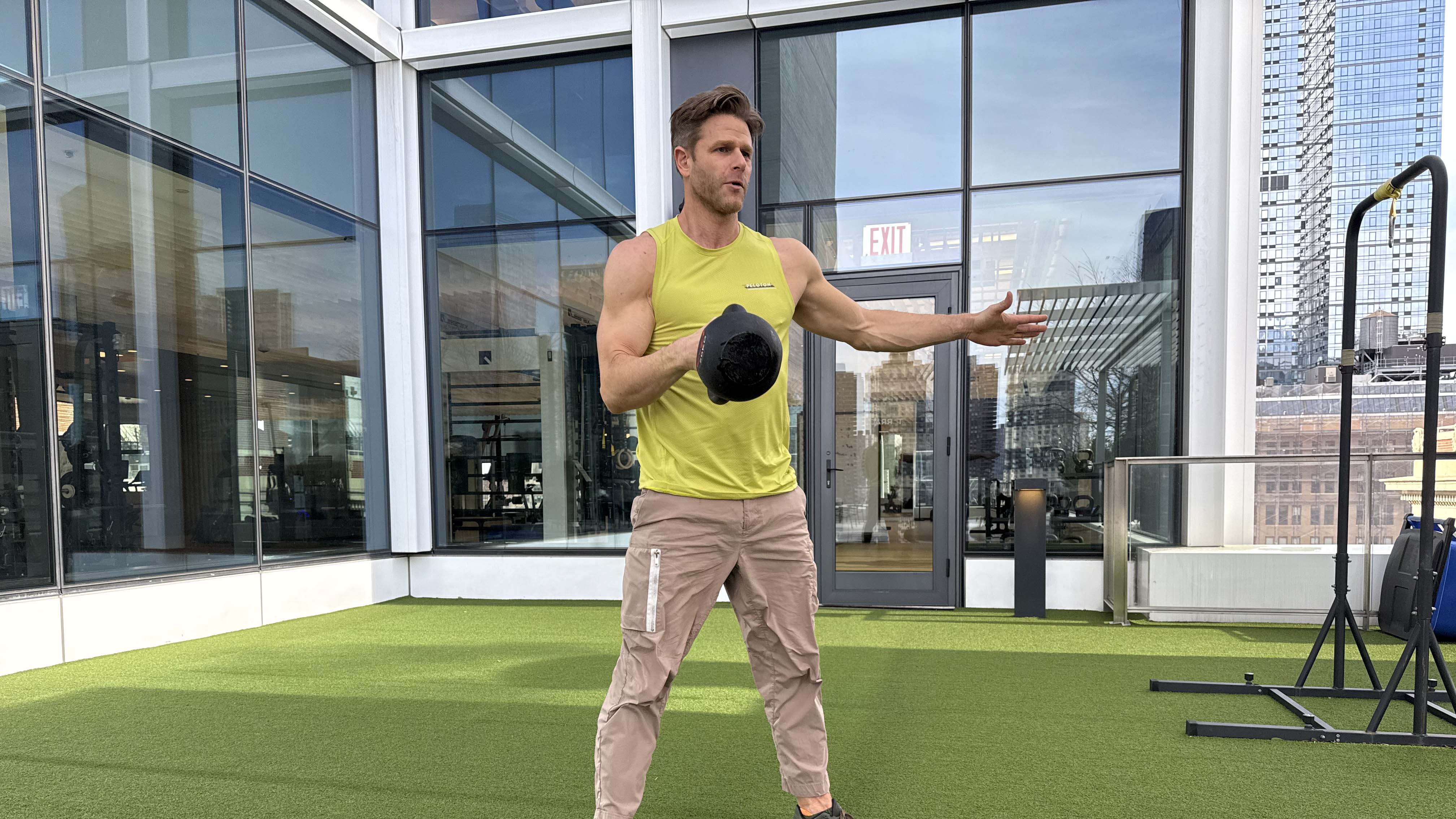a photo of Peloton trainer Andy Speer doing a kettlebell single-arm clean
