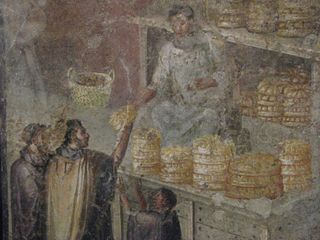 The newly deciphered inscription discusses a four-year famine in Pompeii and efforts of a wealthy man to alleviate the distress by distributing free bread. The account could also be depicted in a famous mosaic from Pompeii, which shows bread being distributed during a famine. 