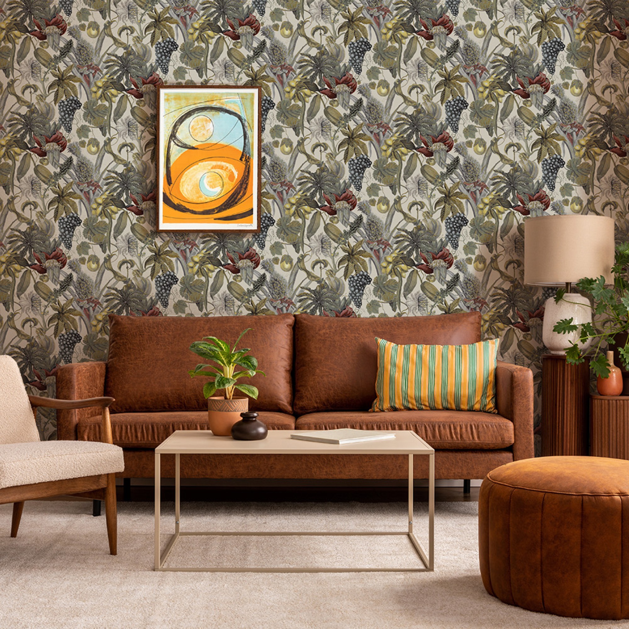 A living room with a bold tropical floral wallpaper from Wallpaper Direct and a brown leather sofa