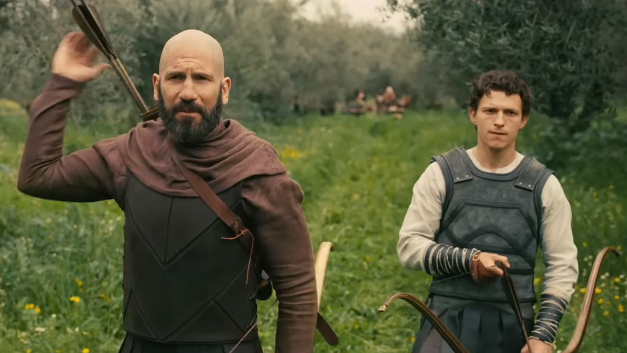 Tom Holland and Jon Bernthal hunting in The Odyssey, both are wearing some leather armor.