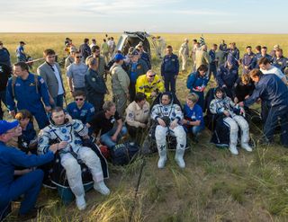 NASA astronaut Terry Virts (left), Russian cosmonaut Anton Shklaperov and Italian astronaut Samantha Cristoforetti sit in chairs outside the Soyuz TMA-15M spacecraft just minutes after they landed in a remote area near the town of Zhezkazgan, Kazakhstan on June 11, 2015. They spent nearly 200 days on the International Space Station.